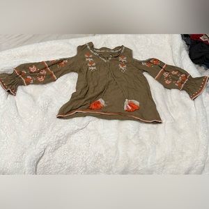 Women’s long sleeved brown shirt with orange designs and drawstrings, size small